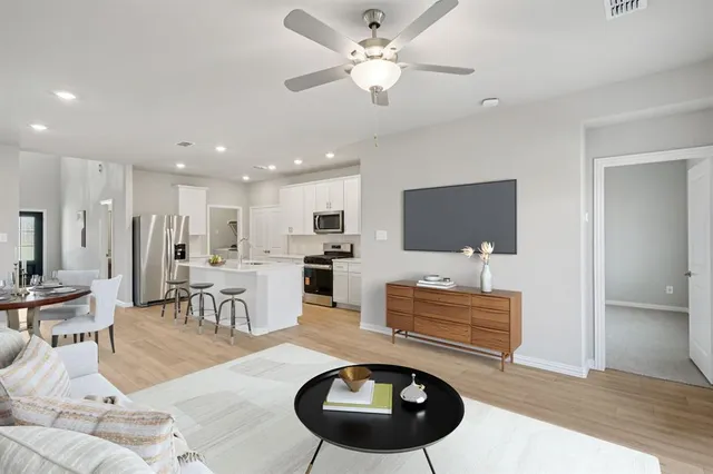a bathroom with a toilet sink a mirror and vanity