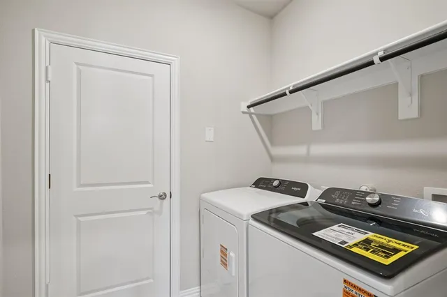 an empty room with a chandelier fan and closet area