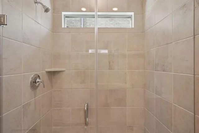 a bathroom with a double vanity sink a mirror and a shower