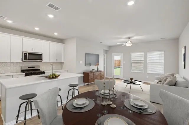 a kitchen that has a sink and a stove in it