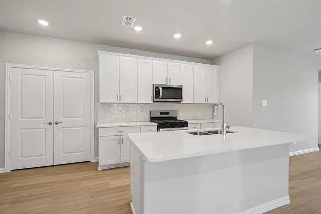 a kitchen with a sink and cabinets