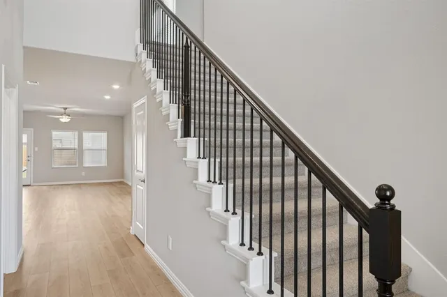 a view of kitchen with kitchen island wooden floor center island and stainless steel appliances