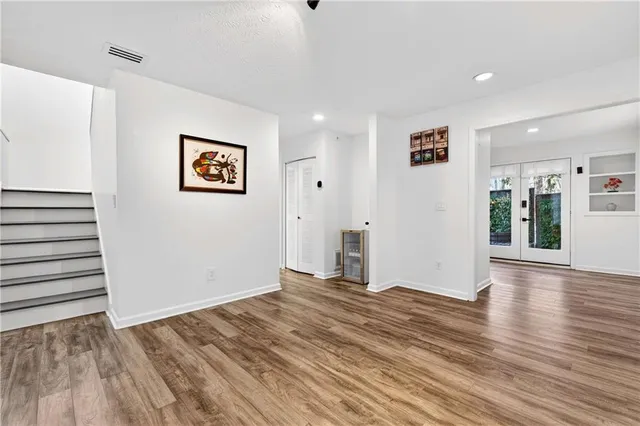 a view of a room with wooden floor and window