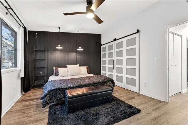 a bedroom with a bed and wooden floor