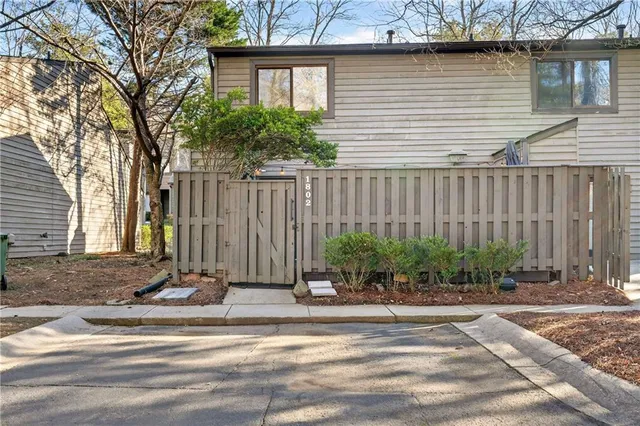 a view of a house with a small yard and plants