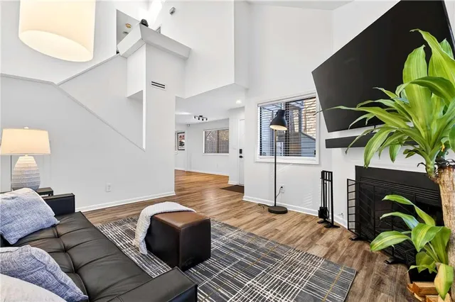 a living room with furniture flowerpot and wooden floor