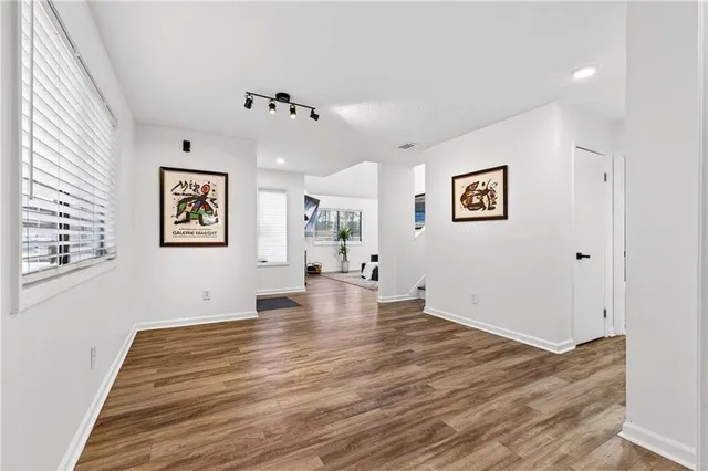 a view of an empty room with wooden floor