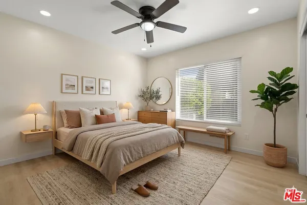 a bedroom with bed and a large window