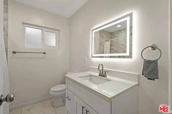 a bathroom with a sink toilet and vanity