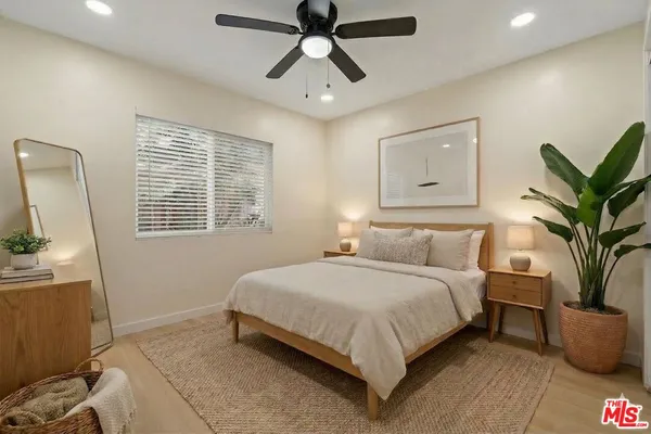 a bedroom with a large bed and a chandelier