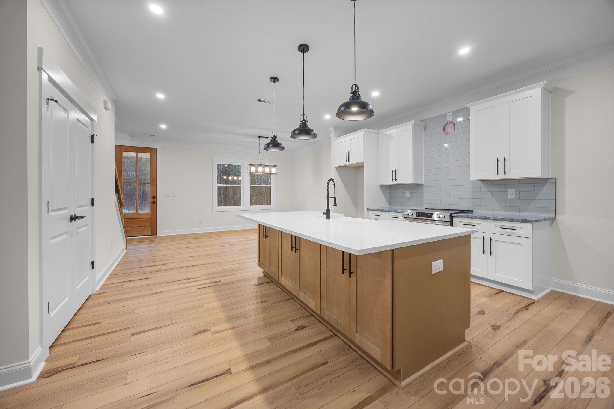 635 Fiber Acres A Street Cleveland, NC 27013 - Photo 16 of 42 a kitchen with stainless steel appliances sink cabinets and wooden floor