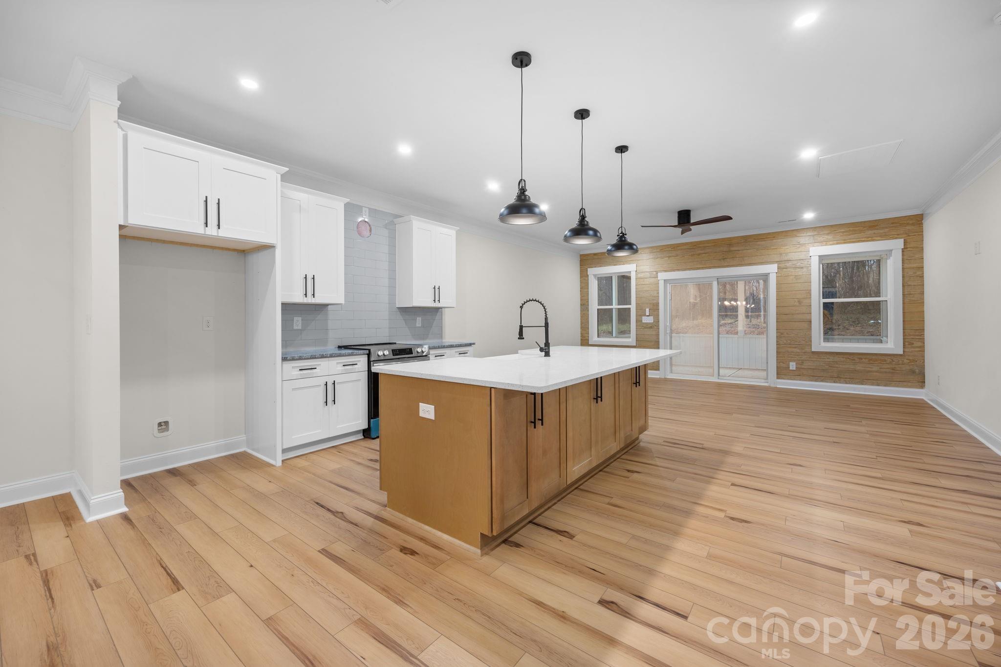 635 Fiber Acres A Street Cleveland, NC 27013 - Photo 19 of 42 a large kitchen with stainless steel appliances granite countertop a large counter top a sink and a wooden floors