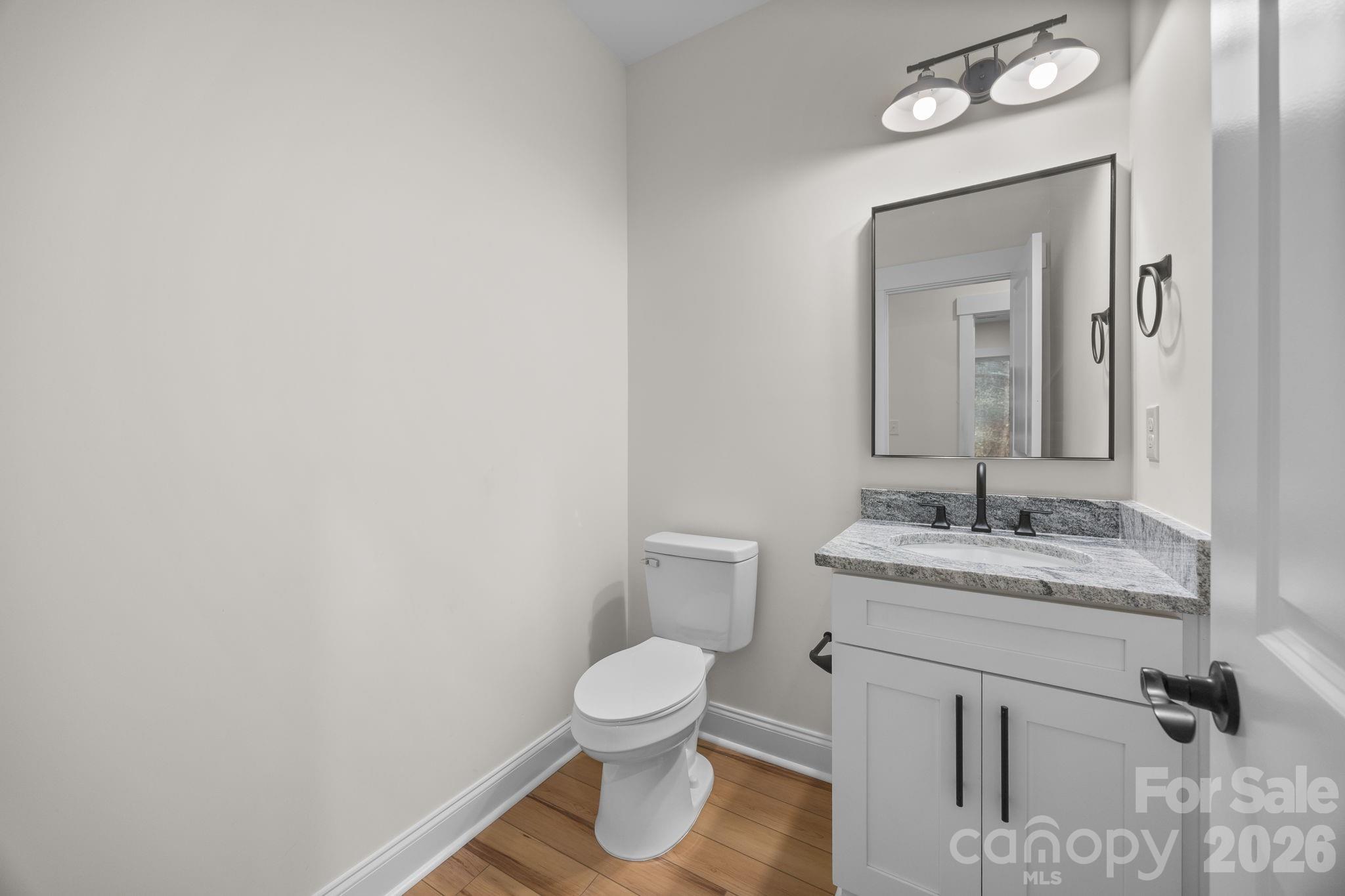 635 Fiber Acres A Street Cleveland, NC 27013 - Photo 25 of 42 a bathroom with a granite countertop toilet sink and mirror