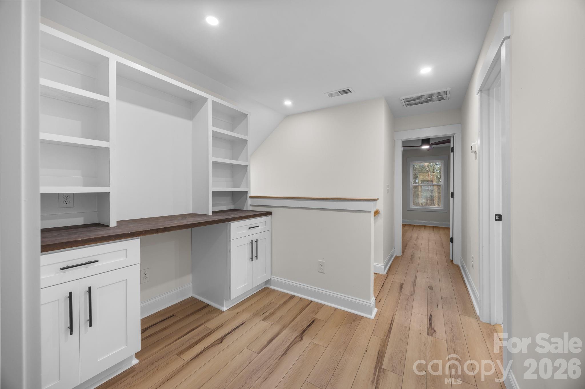 635 Fiber Acres A Street Cleveland, NC 27013 - Photo 30 of 42 a hallway with wooden floor cabinets and a kitchen space