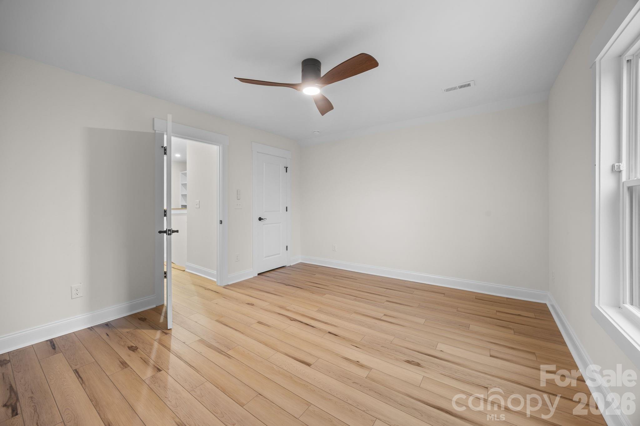 635 Fiber Acres A Street Cleveland, NC 27013 - Photo 35 of 42 an empty room with wooden floor and windows