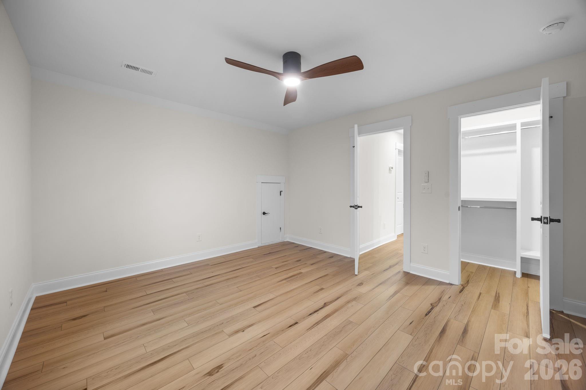635 Fiber Acres A Street Cleveland, NC 27013 - Photo 36 of 42 an empty room with wooden floor and a ceiling fan