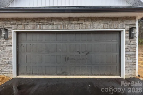 a view of a hallway with wooden floor and entryway