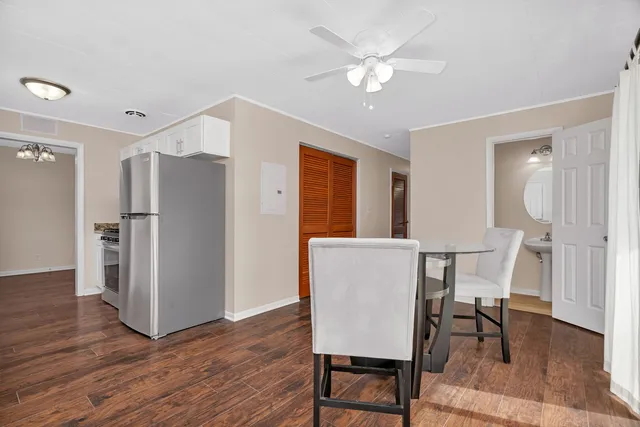 a view of a dining room with furniture wooden floor and a chandelier