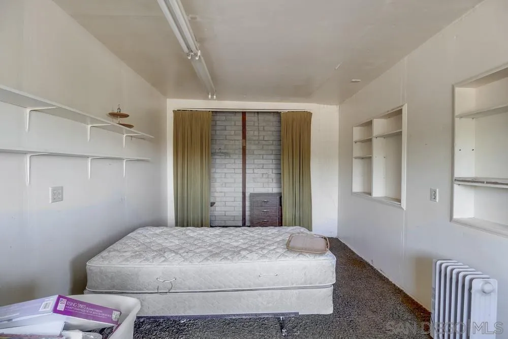 1735 Foss Road Alpine, CA 91901 - Photo 54 of 69 a bedroom with a bed and a window