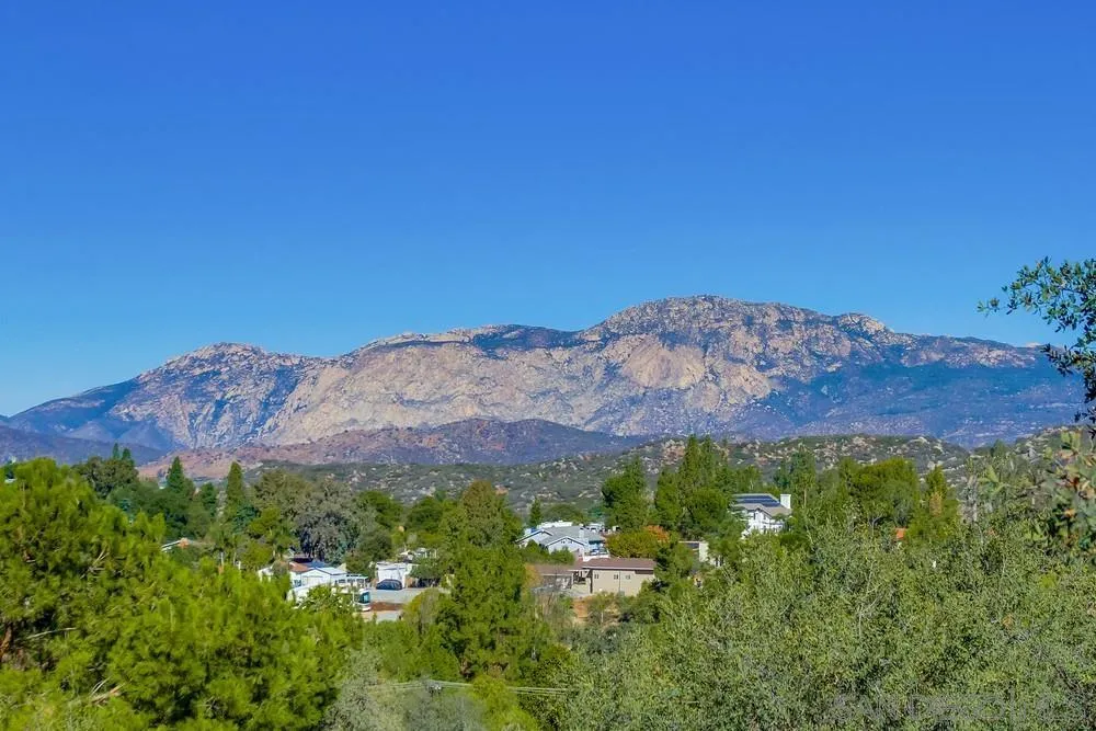 1735 Foss Road Alpine, CA 91901 - Photo 66 of 69 a view of a lush green field with mountains in the background