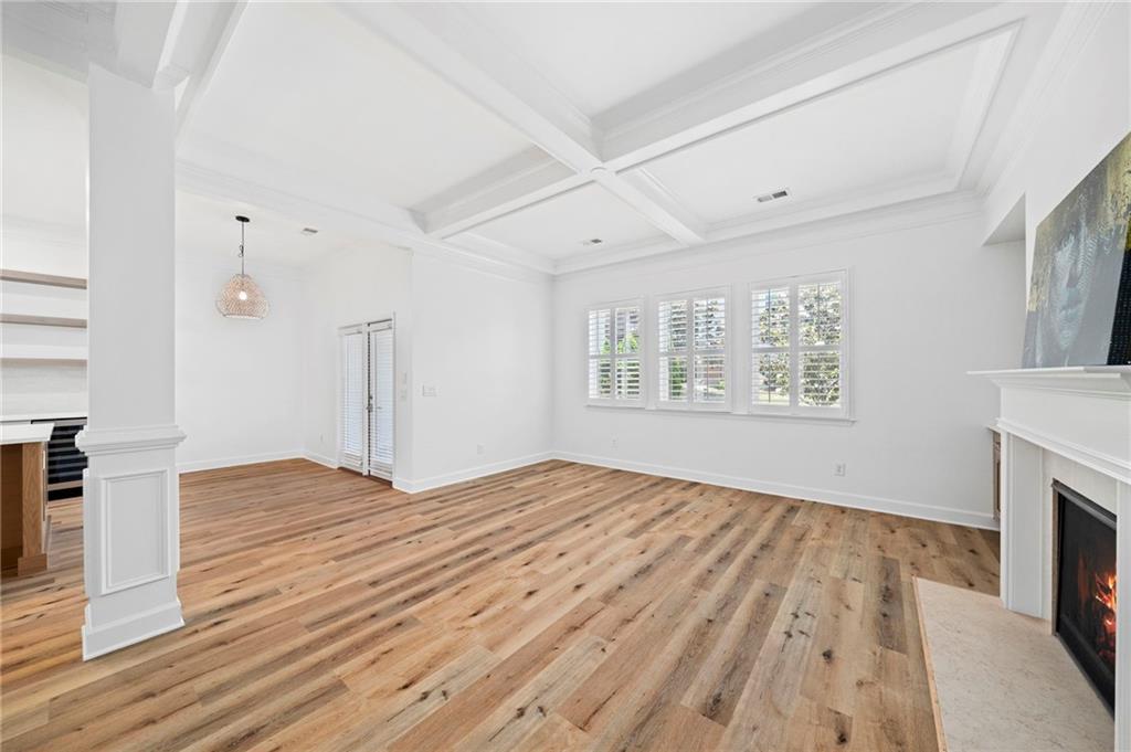 3628 Ashcroft Bend Atlanta, GA 30319 - Photo 20 of 44 an empty room with wooden floor fireplace and windows