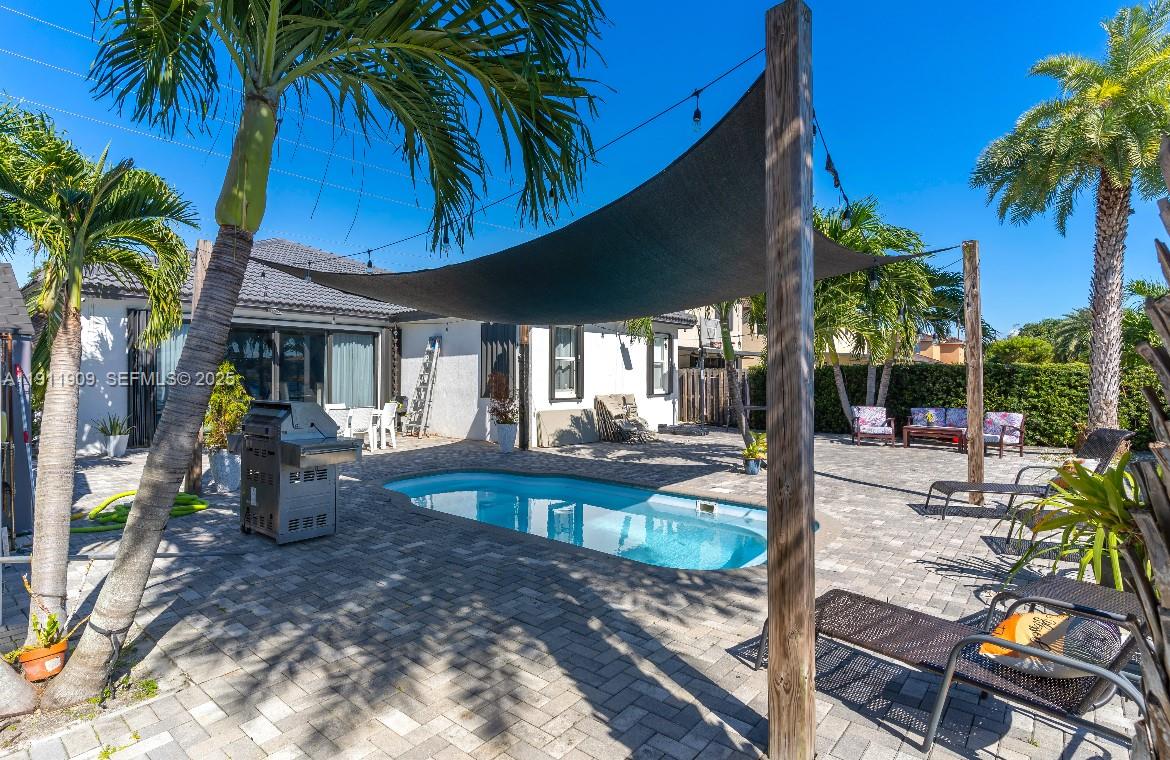13000 Southwest 280th Street Homestead, FL 33033 - Photo 18 of 28 a view of a swimming pool with chairs and table in the patio