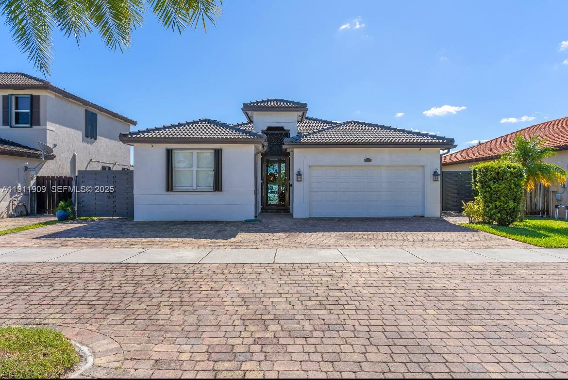 13000 Southwest 280th Street Homestead, FL 33033 - Photo 5 of 28 a front view of a house with a yard and a garage