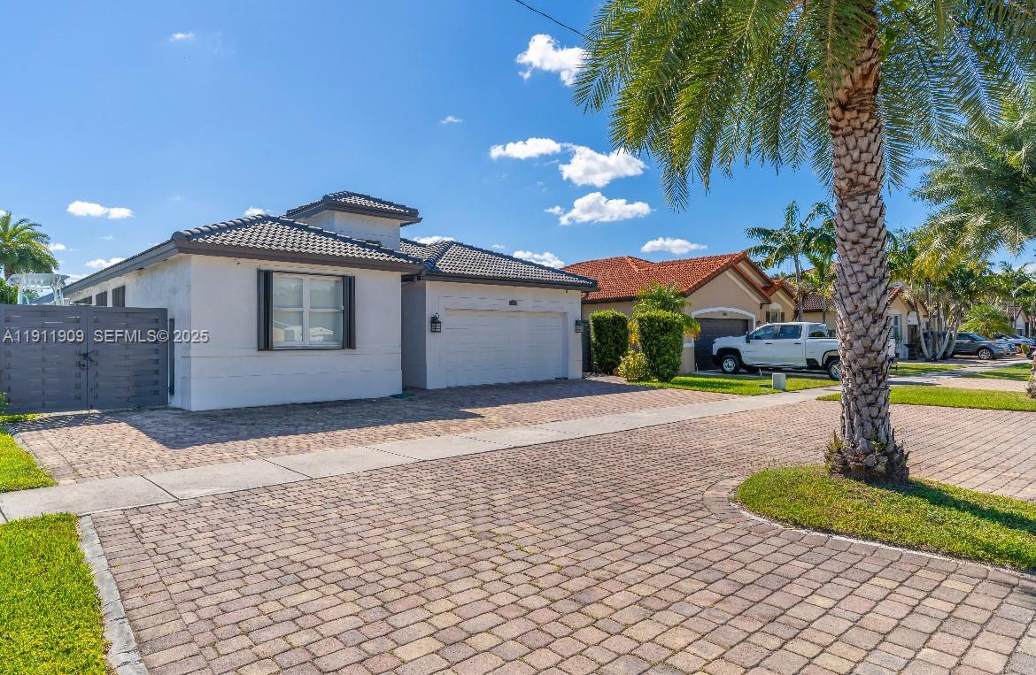 13000 Southwest 280th Street Homestead, FL 33033 - Photo 6 of 28 a front view of a house with a yard and potted plants