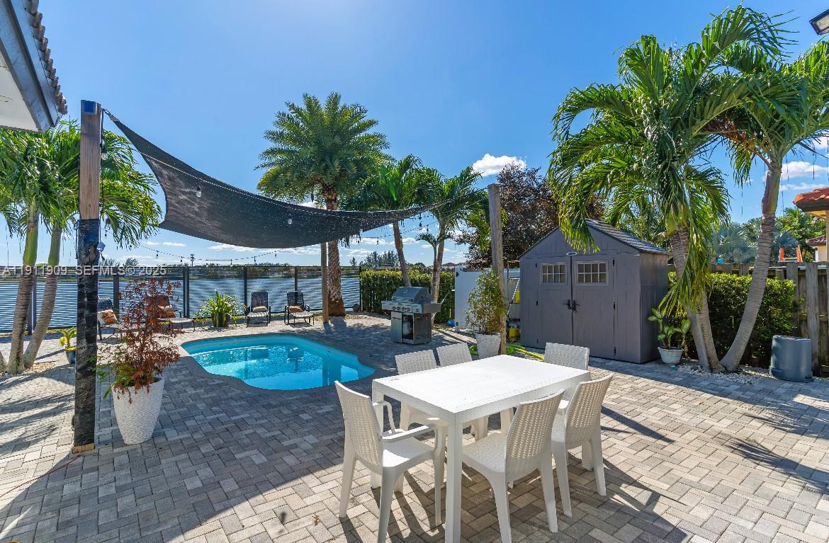 13000 Southwest 280th Street Homestead, FL 33033 - Photo 10 of 28 a view of a patio with table and chairs potted plants and palm tree