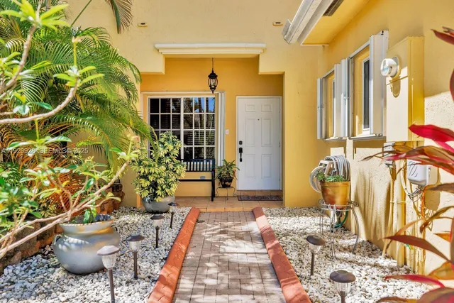a view of a porch with potted plants