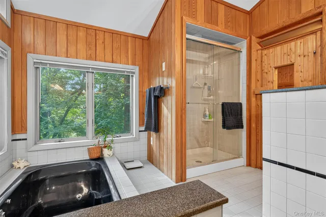 a view of a dining room with furniture large windows and wooden floor