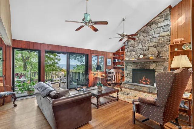 a living room with patio furniture and a fireplace