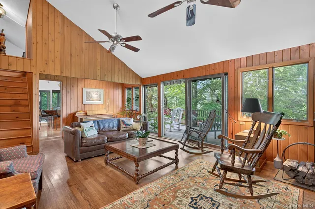 a kitchen with stainless steel appliances granite countertop a stove a sink dishwasher and a refrigerator with wooden floor