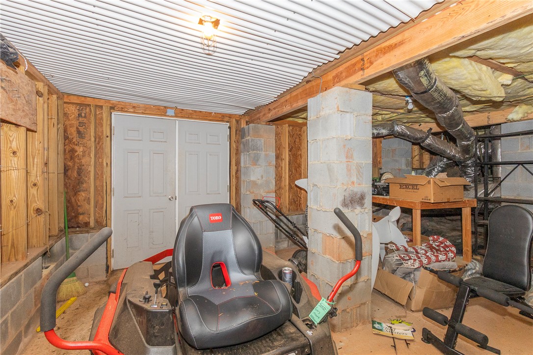861 North Old Pendleton Road Liberty, SC 29657 - Photo 36 of 45 Unfinished basement space, ideal for storage or future customization, features durable concrete block foundation walls and exposed wood framing.