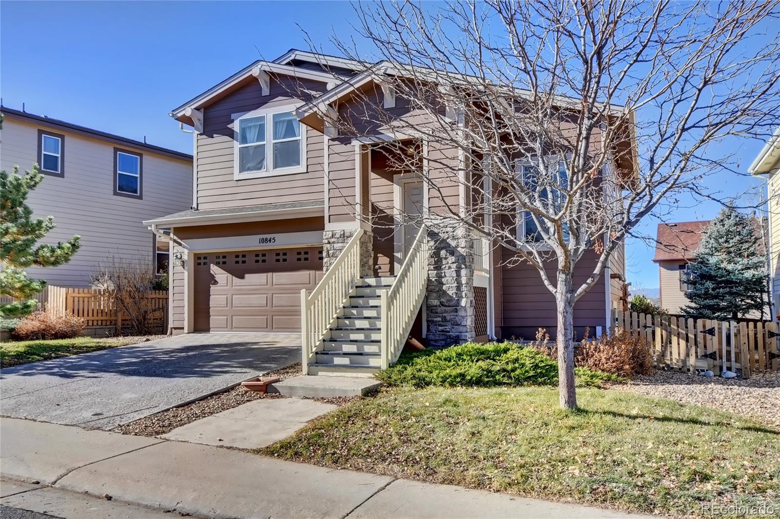 10845 Towerbridge Road Highlands Ranch, CO 80130 - Photo 3 of 35 a front view of a house with garden