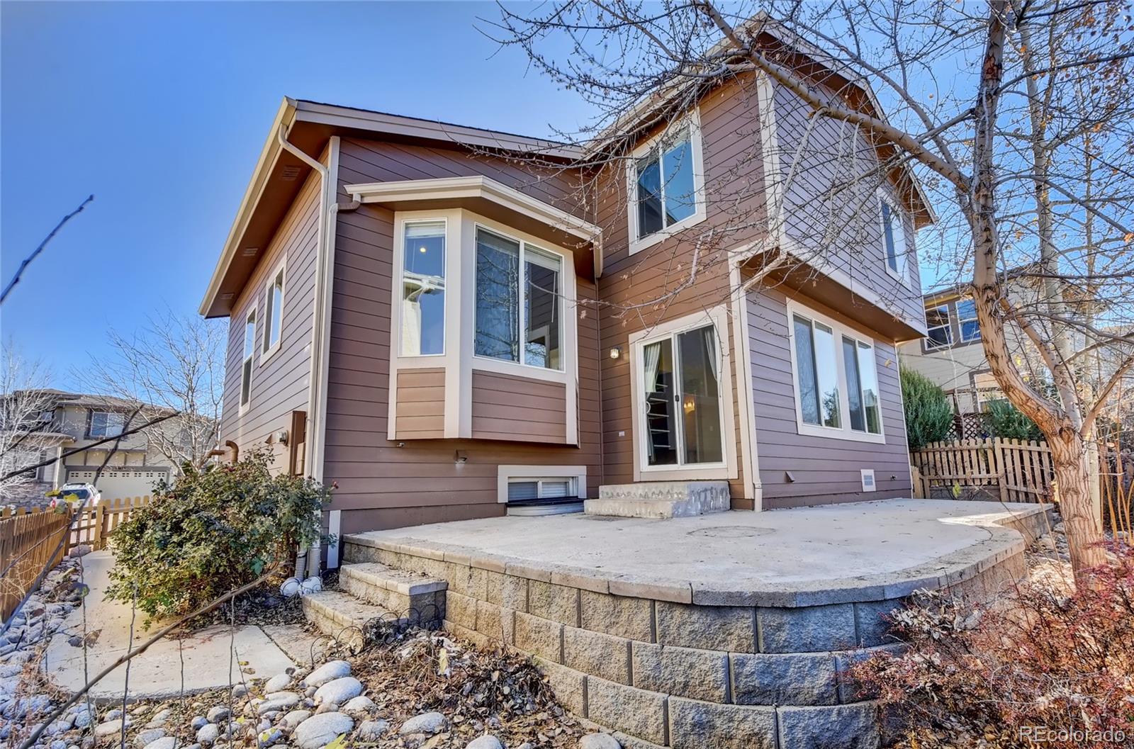 10845 Towerbridge Road Highlands Ranch, CO 80130 - Photo 4 of 35 a front view of a house with a yard
