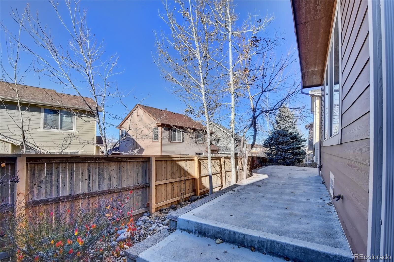 10845 Towerbridge Road Highlands Ranch, CO 80130 - Photo 8 of 35 a view of a house with wooden fence