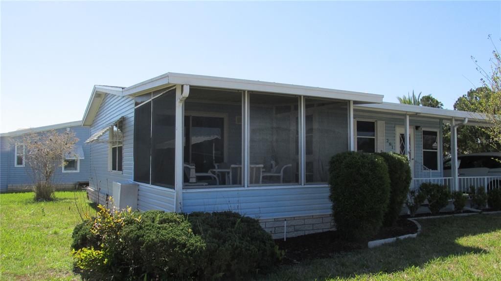 a view of house with backyard and porch