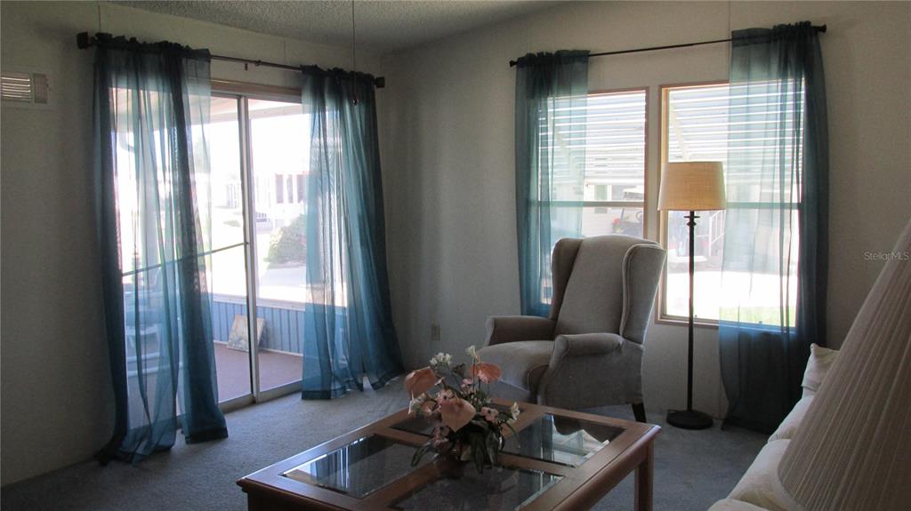 261 Ramsgate Way Haines City, FL 33844 - Photo 12 of 28 a living room with furniture and large windows