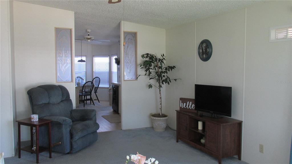 261 Ramsgate Way Haines City, FL 33844 - Photo 14 of 28 a living room with furniture and a flat screen tv