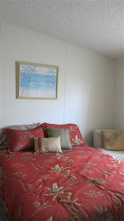 261 Ramsgate Way Haines City, FL 33844 - Photo 16 of 28 a bedroom with a bed and a painting on the wall