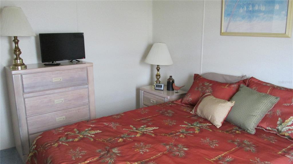 261 Ramsgate Way Haines City, FL 33844 - Photo 17 of 28 a bedroom with a bed and a flat screen tv