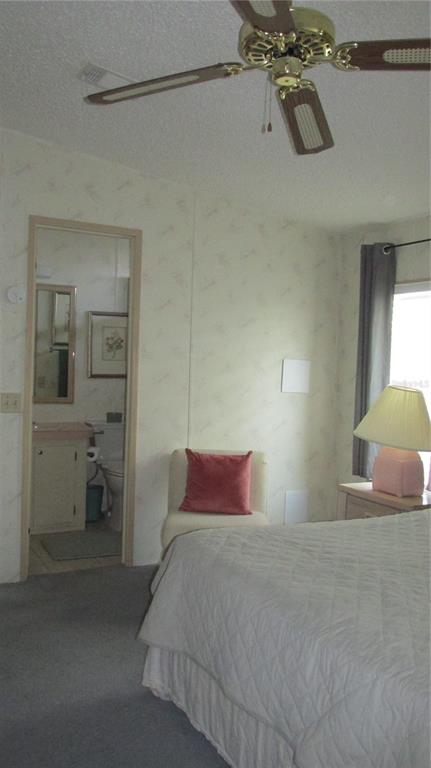 261 Ramsgate Way Haines City, FL 33844 - Photo 22 of 28 a bedroom with a bed and a chandelier