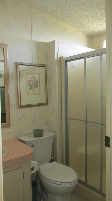 261 Ramsgate Way Haines City, FL 33844 - Photo 23 of 28 a white toilet sitting next to a bathroom sink