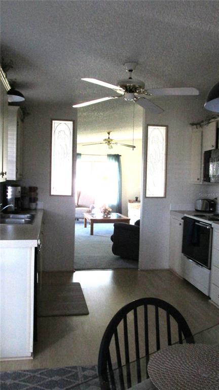 261 Ramsgate Way Haines City, FL 33844 - Photo 5 of 28 a kitchen with a table chairs sink and cabinets