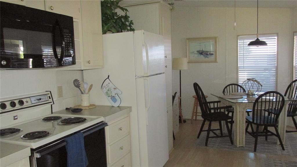 261 Ramsgate Way Haines City, FL 33844 - Photo 7 of 28 a kitchen with a stove and a refrigerator