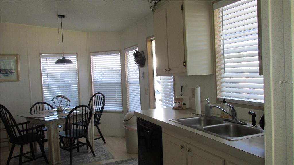 261 Ramsgate Way Haines City, FL 33844 - Photo 8 of 28 a kitchen with sink table and chairs