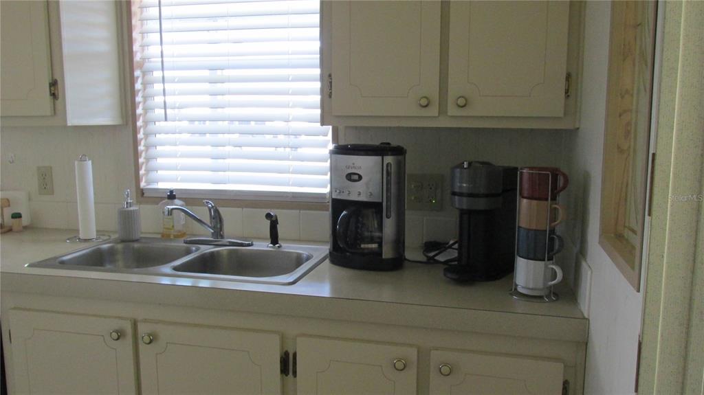 261 Ramsgate Way Haines City, FL 33844 - Photo 9 of 28 a kitchen with a sink and cabinets