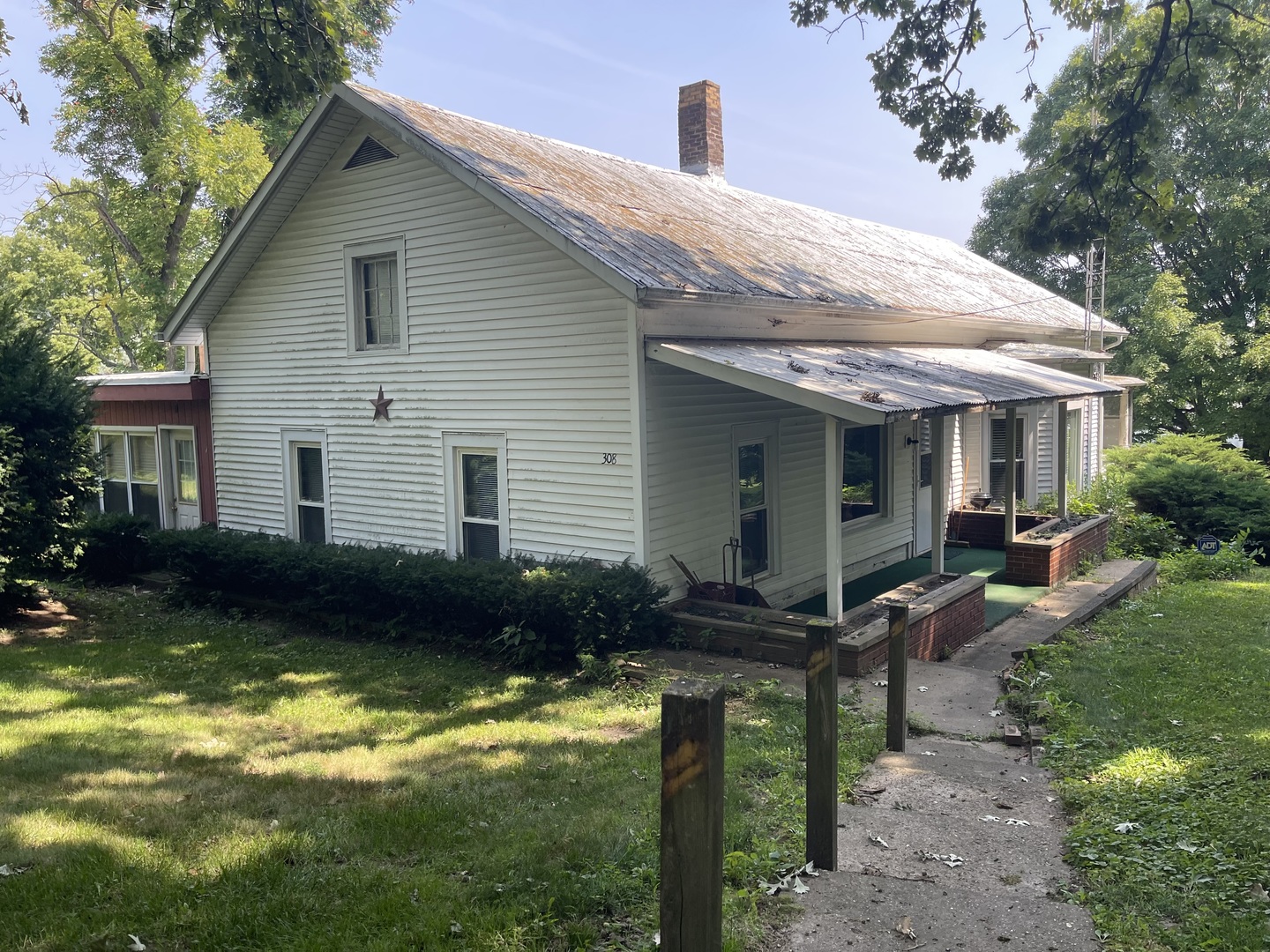 a backyard of a house with garden barbeque oven and outdoor seating