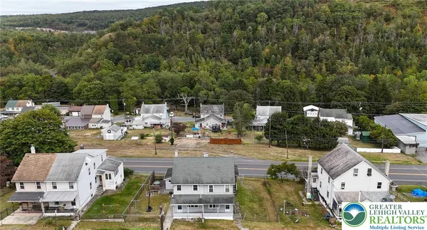 an aerial view of residential houses with outdoor space